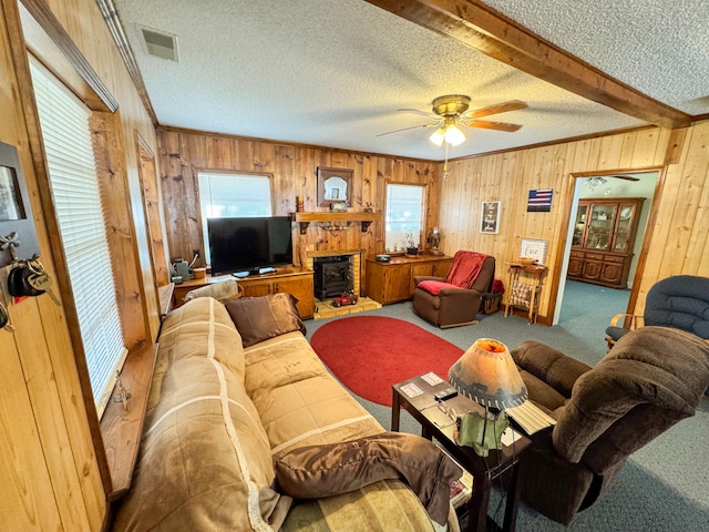 carpeted living room with a textured ceiling, a healthy amount of sunlight, ceiling fan, and crown molding