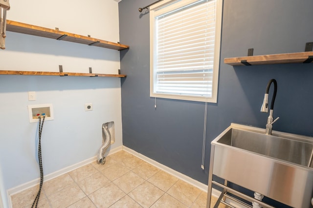 clothes washing area featuring washer hookup, light tile patterned flooring, a sink, electric dryer hookup, and laundry area