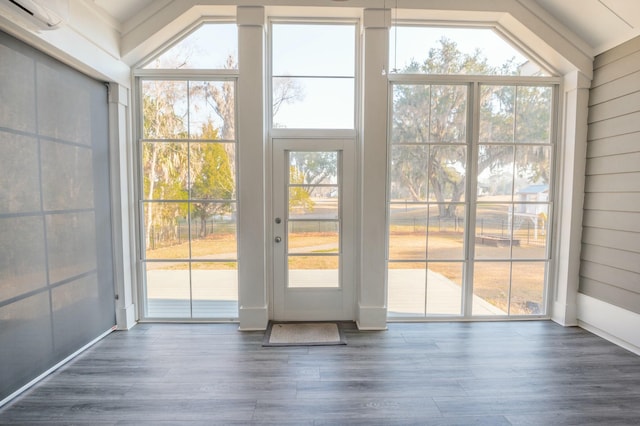 doorway to outside with a wealth of natural light and wood finished floors