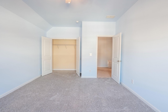 unfurnished bedroom featuring a ceiling fan, a closet, light colored carpet, and baseboards