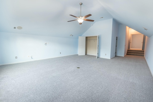 bonus room featuring lofted ceiling, light carpet, visible vents, baseboards, and a ceiling fan