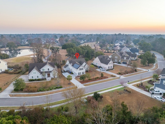 aerial view at dusk featuring a residential view