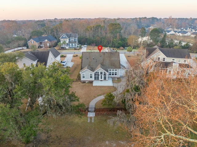 birds eye view of property featuring a forest view and a residential view