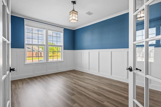 202 Buttercup Ln, Summerville, SC 29486 - unfurnished room with a decorative wall, crown molding, a wainscoted wall, and wood finished floors