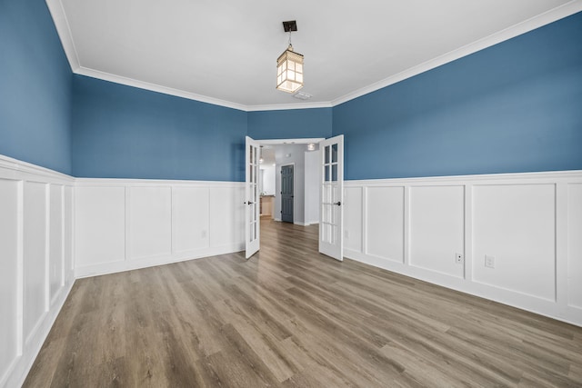 202 Buttercup Ln, Summerville, SC 29486 - spare room with french doors, a decorative wall, ornamental molding, wood finished floors, and wainscoting