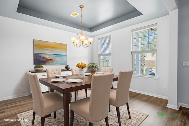 202 Buttercup Ln, Summerville, SC 29486 - dining area featuring dark wood-style flooring, a chandelier, plenty of natural light, and a tray ceiling