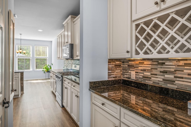 202 Buttercup Ln, Summerville, SC 29486 - kitchen with appliances with stainless steel finishes, wood finished floors, backsplash, a chandelier, and dark stone countertops