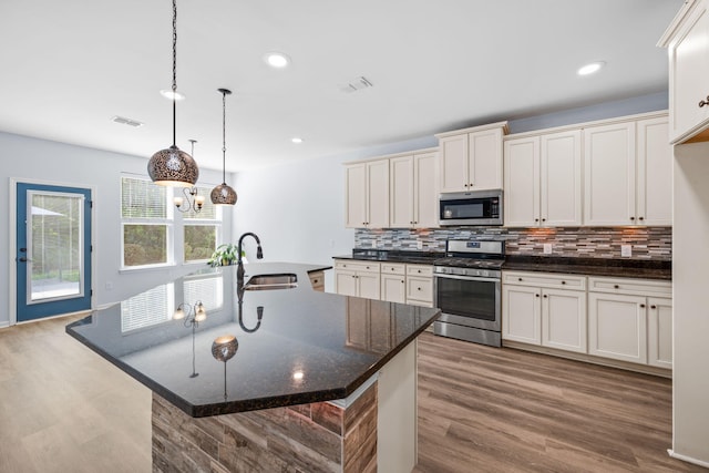 202 Buttercup Ln, Summerville, SC 29486 - kitchen with appliances with stainless steel finishes, decorative backsplash, wood finished floors, recessed lighting, and pendant lighting