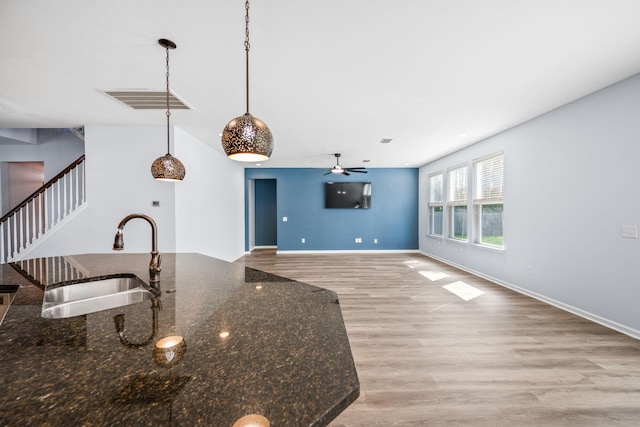 202 Buttercup Ln, Summerville, SC 29486 - kitchen with wood finished floors, ceiling fan, dark stone countertops, and pendant lighting