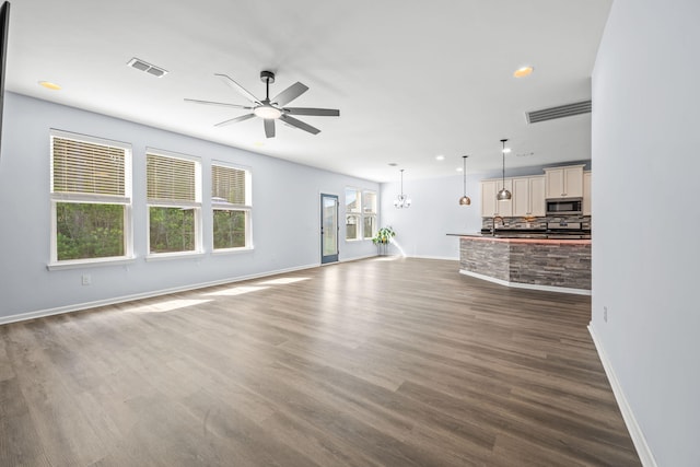 202 Buttercup Ln, Summerville, SC 29486 - unfurnished living room featuring a ceiling fan, dark wood-style flooring, recessed lighting, and a chandelier