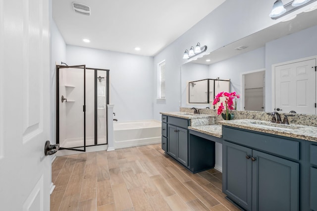 202 Buttercup Ln, Summerville, SC 29486 - bathroom featuring a shower stall, a garden tub, double vanity, wood finished floors, and recessed lighting