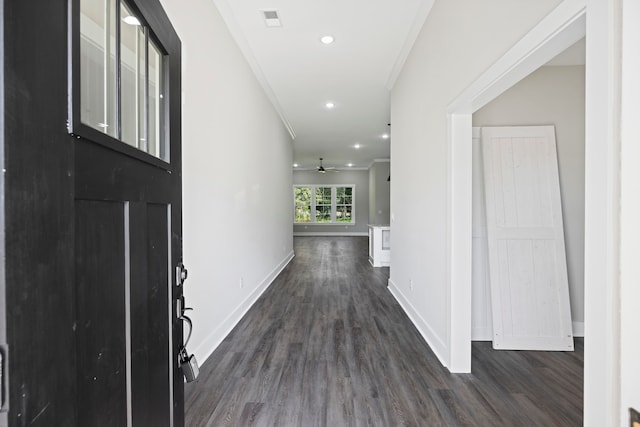 entryway featuring ornamental molding, ceiling fan, and dark wood-type flooring