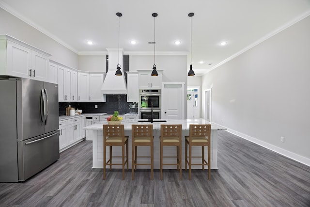 621 Plantation Dr, Santee, SC 29142 - kitchen with an island with sink, stainless steel appliances, light countertops, tasteful backsplash, and white cabinetry