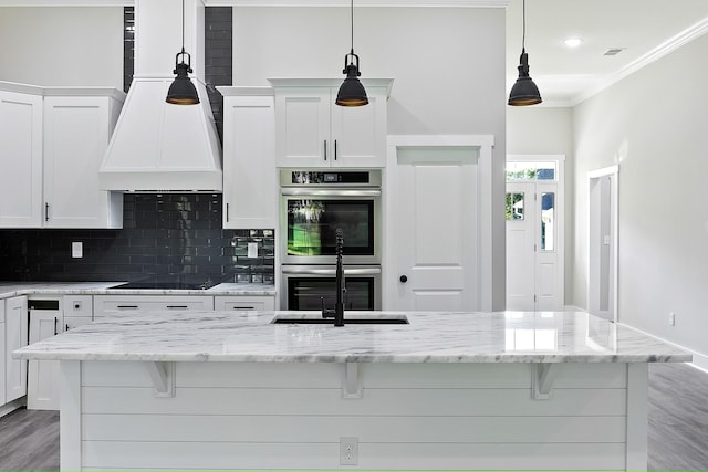 621 Plantation Dr, Santee, SC 29142 - kitchen featuring black electric cooktop, a sink, tasteful backsplash, light wood-type flooring, and stainless steel double oven