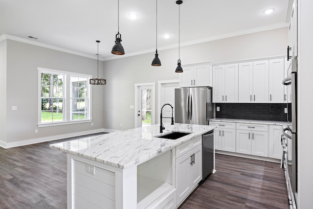 kitchen featuring light stone counters, white cabinets, a center island with sink, and stainless steel appliances