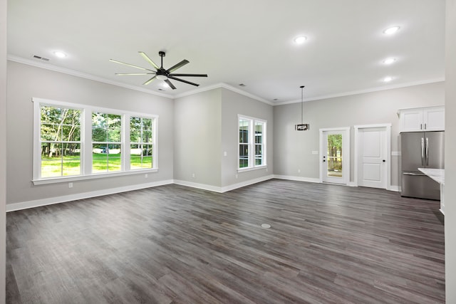 unfurnished living room featuring ornamental molding, a wealth of natural light, ceiling fan, and dark hardwood / wood-style flooring