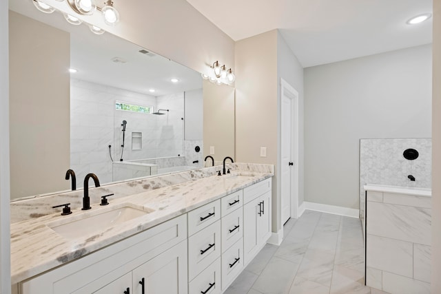 bathroom featuring tiled shower and vanity