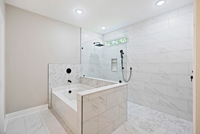 bathroom featuring shower with separate bathtub