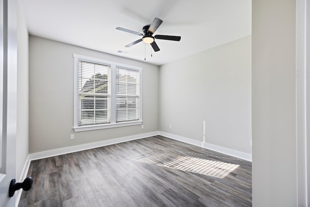 empty room featuring dark hardwood / wood-style flooring and ceiling fan