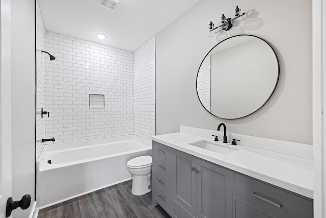 621 Plantation Dr, Santee, SC 29142 - full bath featuring wood finished floors, vanity, toilet, shower / bathtub combination, and visible vents
