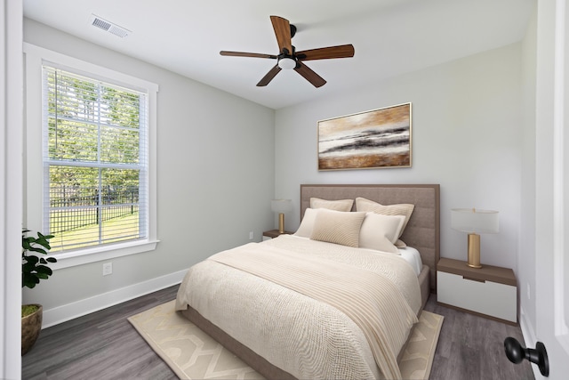 bedroom with ceiling fan and dark hardwood / wood-style floors