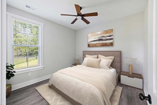 621 Plantation Dr, Santee, SC 29142 - bedroom with baseboards, wood finished floors, visible vents, and ceiling fan
