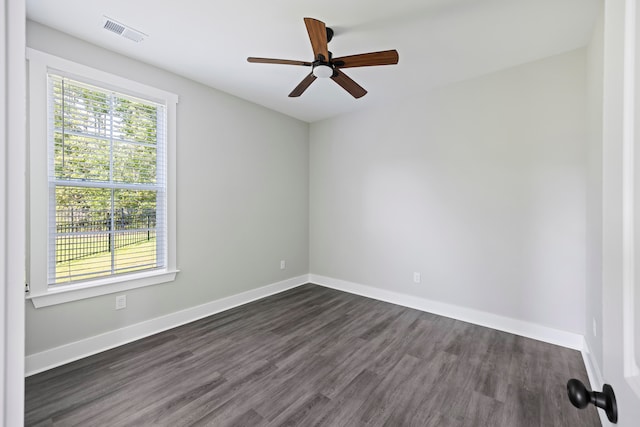 spare room with ceiling fan and dark hardwood / wood-style flooring