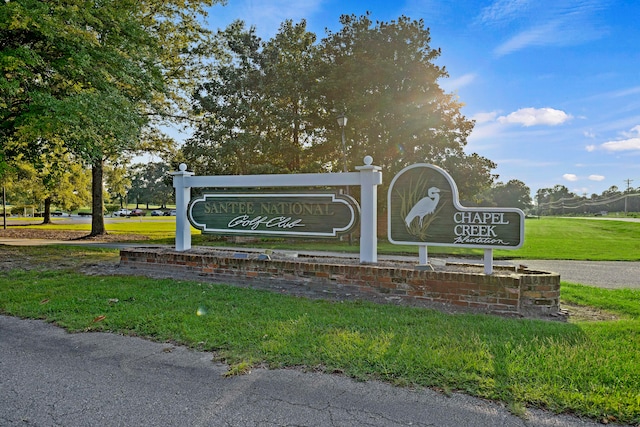 community / neighborhood sign with a lawn