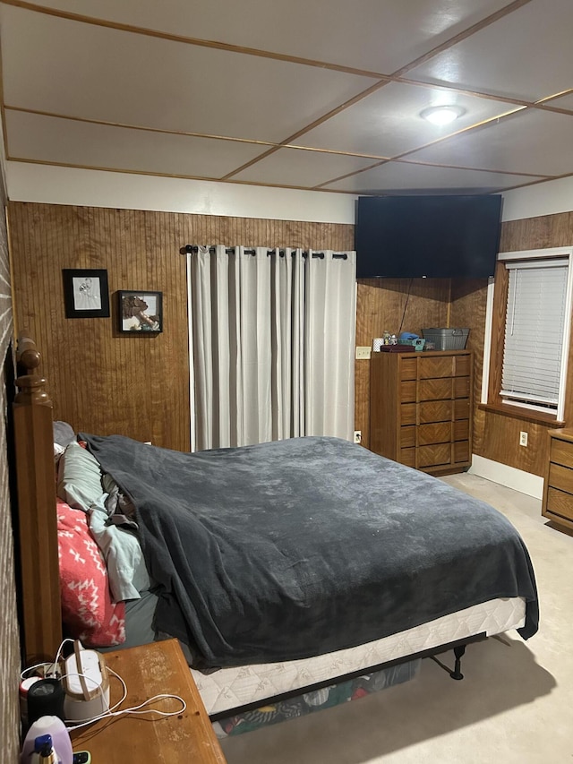 bedroom featuring wooden walls