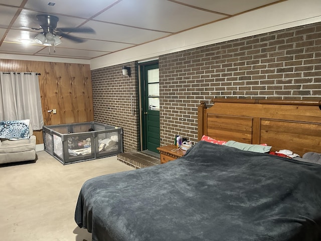 carpeted bedroom featuring access to outside and brick wall