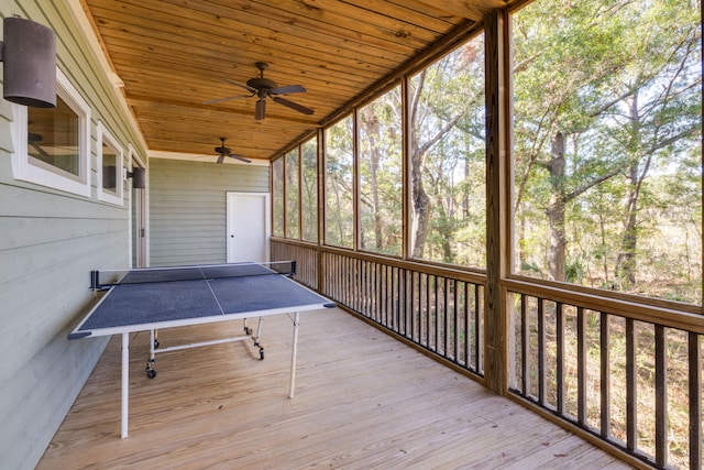 unfurnished sunroom with ceiling fan and wood ceiling