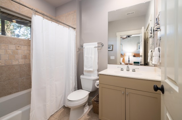 full bathroom featuring ceiling fan, tile patterned flooring, toilet, vanity, and shower / tub combo