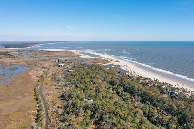 birds eye view of property featuring a water view and a beach view