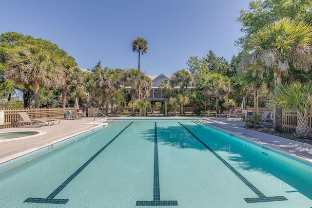 view of pool with a patio area and a hot tub