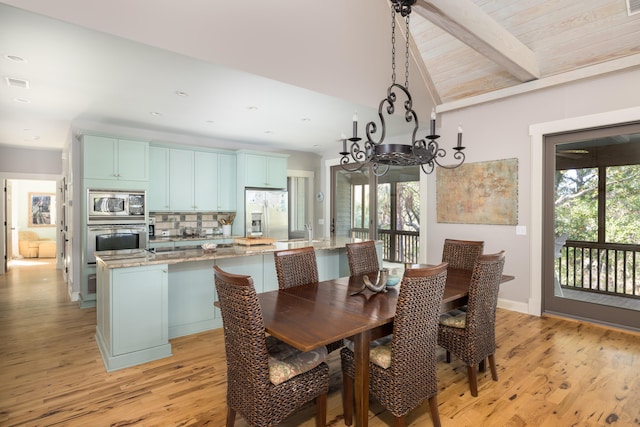 dining space featuring sink, lofted ceiling with beams, wooden ceiling, a chandelier, and light hardwood / wood-style floors