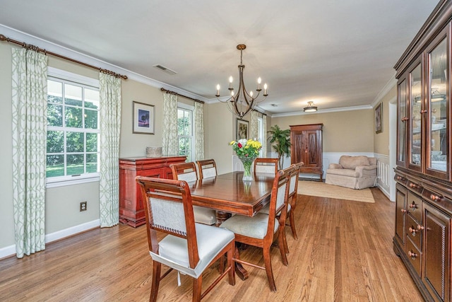 1227 River Rd, Johns Island, SC 29455 - dining area featuring a chandelier, light wood-type flooring, crown molding, and baseboards