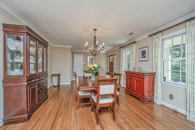 1227 River Rd, Johns Island, SC 29455 - dining area with a chandelier, baseboards, light wood-type flooring, and ornamental molding