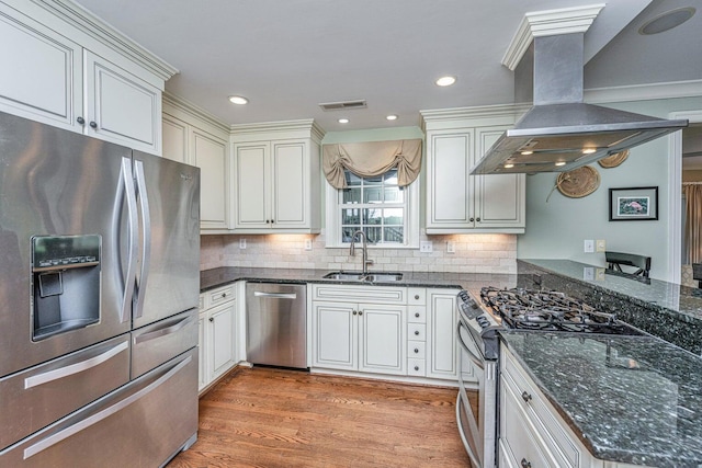 1227 River Rd, Johns Island, SC 29455 - kitchen with appliances with stainless steel finishes, a sink, island exhaust hood, light wood-style floors, and tasteful backsplash