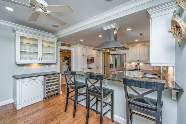1227 River Rd, Johns Island, SC 29455 - kitchen with wine cooler, stainless steel fridge with ice dispenser, island range hood, decorative backsplash, and light wood-type flooring