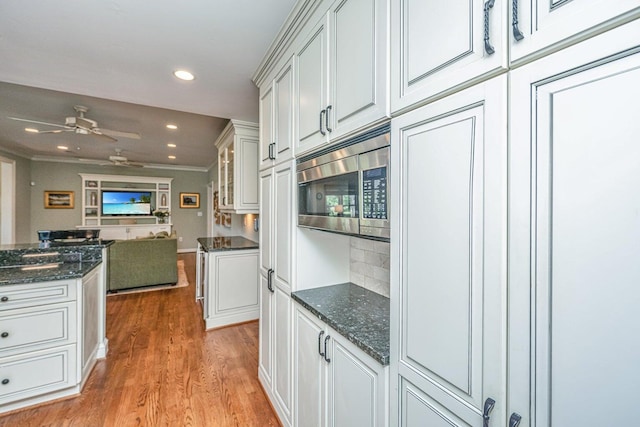 1227 River Rd, Johns Island, SC 29455 - kitchen with stainless steel microwave, light wood finished floors, open floor plan, recessed lighting, and a ceiling fan
