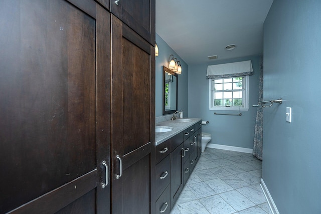 1227 River Rd, Johns Island, SC 29455 - full bathroom with baseboards, double vanity, toilet, and tile patterned flooring