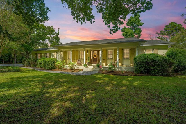 1227 River Rd, Johns Island, SC 29455 - view of front of house featuring covered porch, a yard, and an attached garage