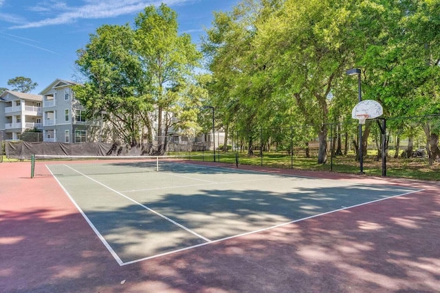 view of tennis court featuring fence