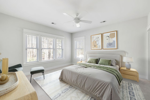 bedroom with carpet floors, baseboards, visible vents, and ceiling fan