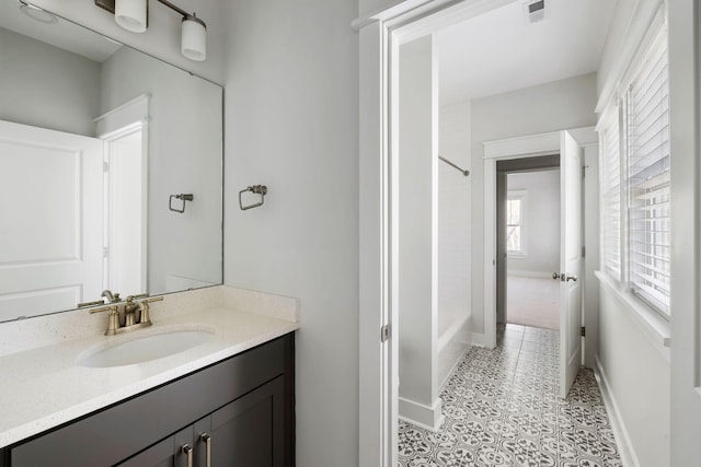 bathroom featuring visible vents, baseboards, tile patterned flooring, vanity, and shower / washtub combination