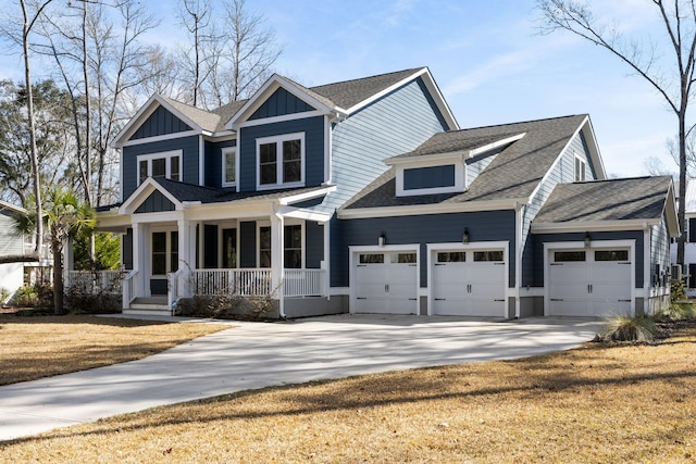 craftsman-style house featuring a garage, driveway, a shingled roof, a porch, and board and batten siding