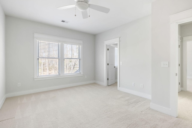 unfurnished bedroom with visible vents, ceiling fan, light carpet, and baseboards