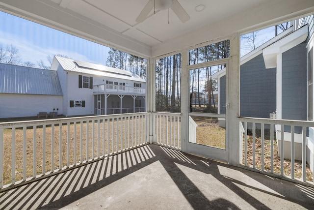 sunroom featuring ceiling fan