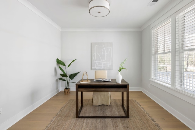 office area with ornamental molding, light wood-type flooring, and baseboards