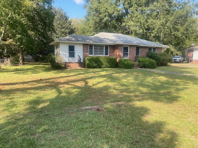 ranch-style home with a front lawn